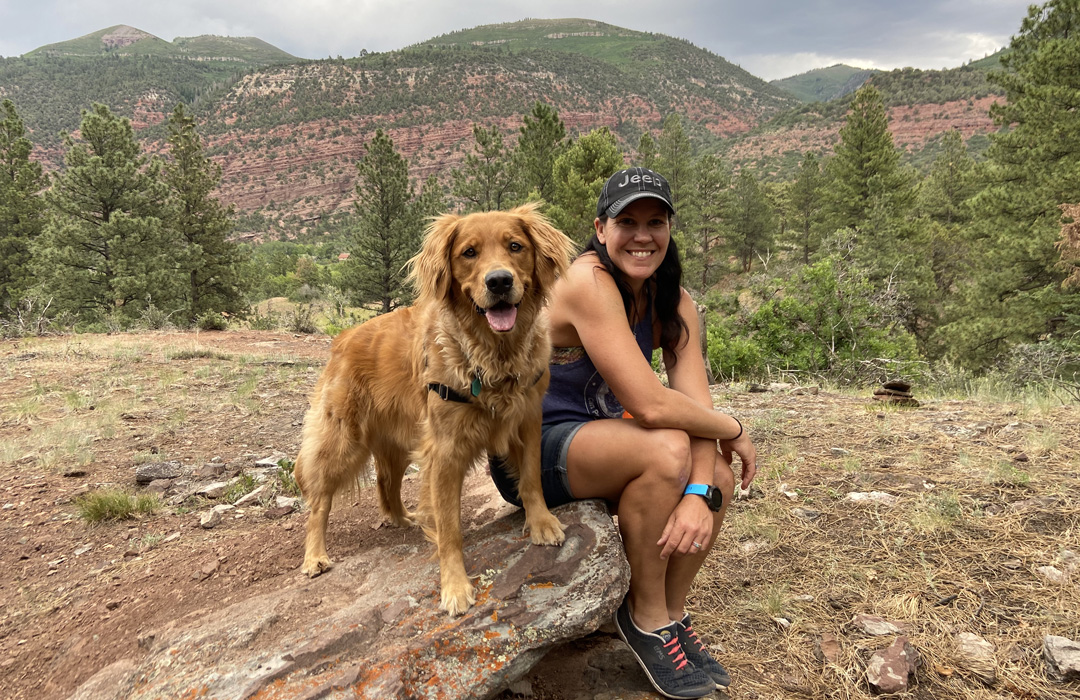Woman Walking Dog in Mountains